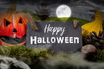 Black slate chalkboard with happy halloween and trick or treat pumpkin decoration with fog
