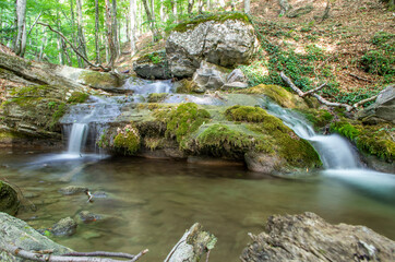 A small waterfall in the forest. Long exposure
