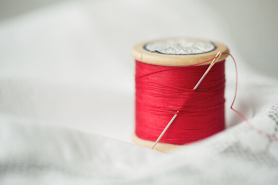 Vintage wooden reel with red cotton