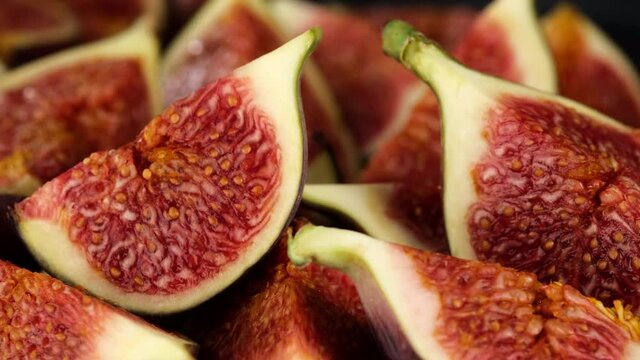 fresh cut figs close up rotating on black background
