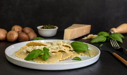 Cooked ravioli or tortelli with cheese, basil, and mushrooms.