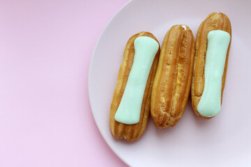 Fresh festachio eclairs on a plate. Homemade baking.