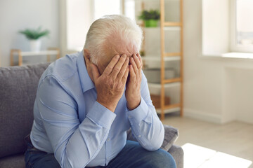 Elderly man, grieving about death of relative or forgotten by family, crying alone
