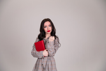 Fototapeta premium girl on white background shows his fist. Female force. Feminism