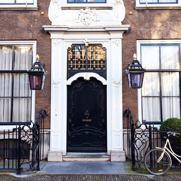 Chique European building facade with bicycle parked against fence