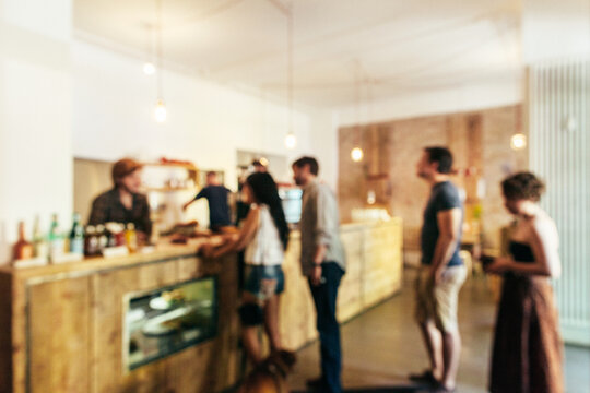 Customers Queuing Up in Coffee Shop Defocused