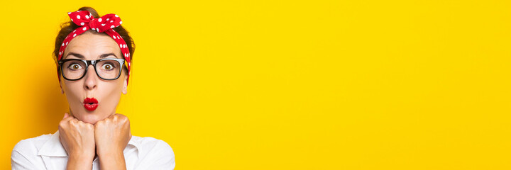 Young woman with a surprised face, wearing glasses and a headband on her head on a yellow background