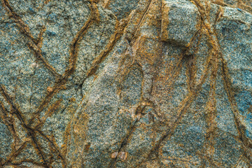 Close up view bright vivid orange brown yellow stone rock shabby cliff cracks texture mountains. Concept of geology, beauty power in nature. Natural summer composition landmark background design