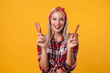 Image of joyful pinup girl posing with lip gloss and eyes cream