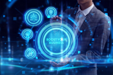 Business, Technology, Internet and network concept. Young businessman working on a virtual screen of the future and sees the inscription: Boost your business