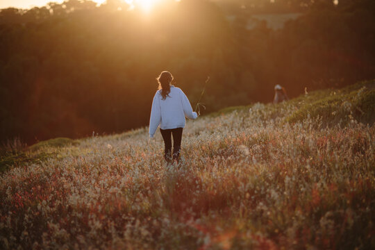 A young woman running into the sunset in California