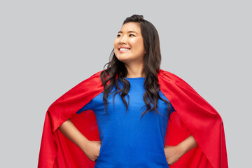 women's power and people concept - happy asian woman in red superhero cape over grey background © Syda Productions