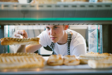 Young man working in a bakery