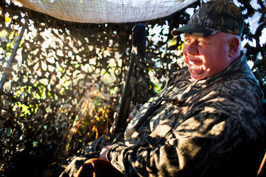 Man Goose Hunting In Duck Blind In Autumn
