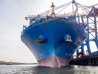 in port there is a huge blue container ship