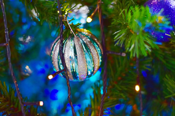 Closeup of Christmas Ball on Christmas Tree with bokeh beautiful background for design and decoration, new year concept, selective focus.