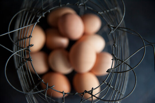 brown eggs inside a wire basket
