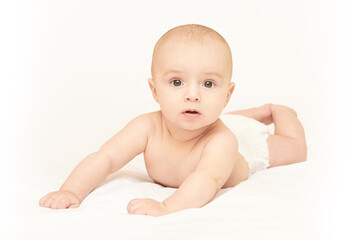 Little pretty kid. Lying at home. White background. Happy expression. Male child portrait. Mother...