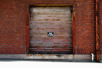 no parking sign on brick building
