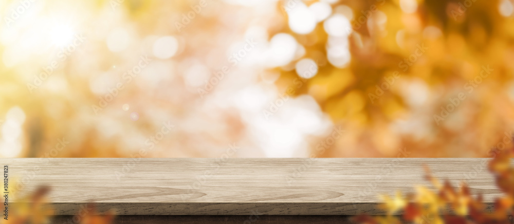 Aufkleber autumn background.empty old rustic wood table with blur forest tree with sunlight,autumn fall backdr