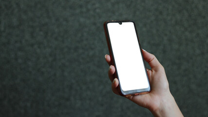 A woman's hand holds a phone.