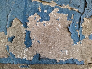 blue painted background texture of old chipped plaster on the concrete wall