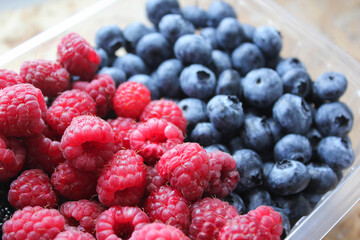 raspberries and blueberries in a bowl