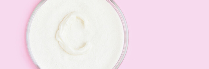 Collagen white powder. Pastel color background. Health product. Woman cosmetics concept. Sport supplement. Skincare cosmetics. Horizontal banner. Pink monochrome