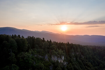 Sunset over the coniferous forest. Lagonaki plateau, Caucasus, Russia