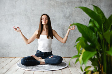 Young women Does Physical Exercises, Yoga And Stretches At Home. Doing sports indoor. Inspiration...