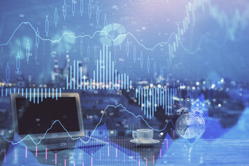 Financial market graph hologram and personal computer on background. Double exposure. Concept of forex.