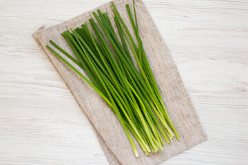 Raw Green Onions on a white wooden background, top view. Flat lay, overhead, from above.