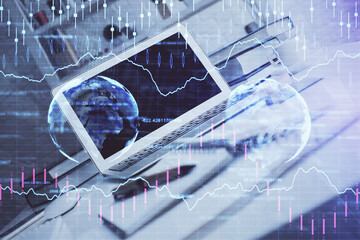 Stock market chart hologram drawn on personal computer background. Multi exposure. Concept of investment.
