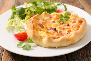 quiche lorraine and lettuce on plate