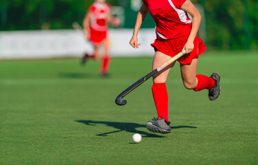 Field Hockey player, ready to pass the ball to a team. Woman team sport concept