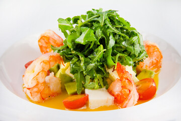 Salad with king prawns, arugula, tomatoes, avocado.