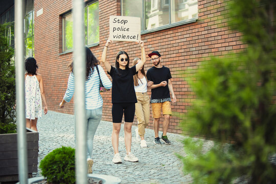 Stop police violence. Dude with sign - woman stands protesting things that annoy her. Solo demonstration right to talk free on the street with sign. Opinion heard by public. Social life, politics