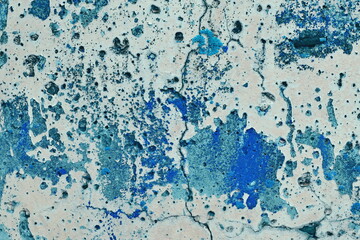 a fragment of an old wall with bright blue spots