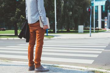 Man standing and waiting to cross the street
