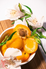 Fototapeta na wymiar Composition of fresh apricots for culinary dessert class or wallpaper. Summer fruit harvest. Healthy vegan eating. Raw recipe. High quality photo