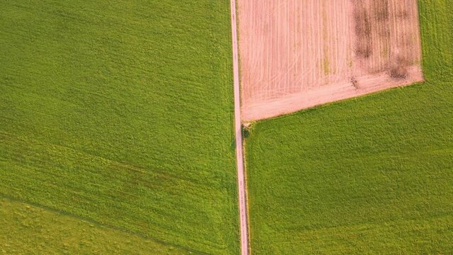 Green and brwon farm land. Drone view. Copy space
