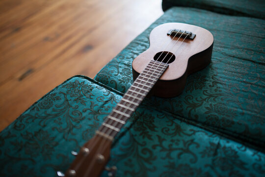 ukulele lying on blue couch