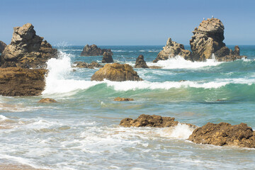 Waves crashing against rocks in the sea