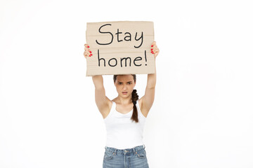 Stay home. Young woman protesting with sign isolated on white studio background. Activism, active social position, protest, actual problems. Meeting against coronavirus spreading. Healthcare.