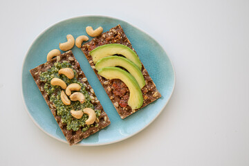 two crackers with pesto on breakfast