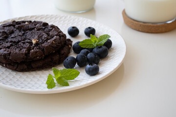 chocolate chip cookies, blueberries and milk