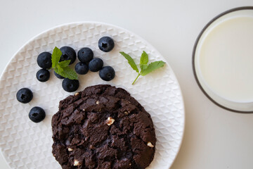chocolate chip cookies, blueberries and milk