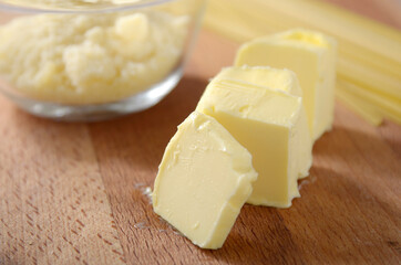 Fototapeta na wymiar Butter cheese on a wooden board