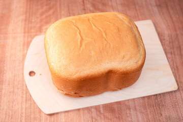 Freshly baked white bread in an electric bread maker. Homemade baking