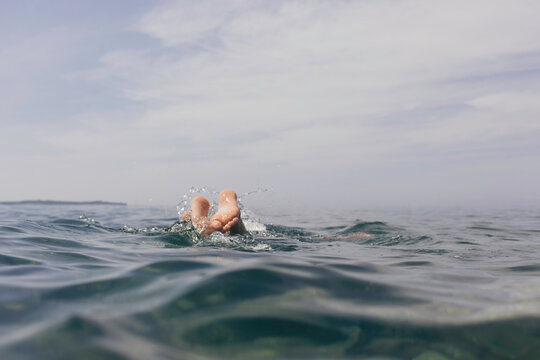 feets from a person taking a dive in the adriatic sea.